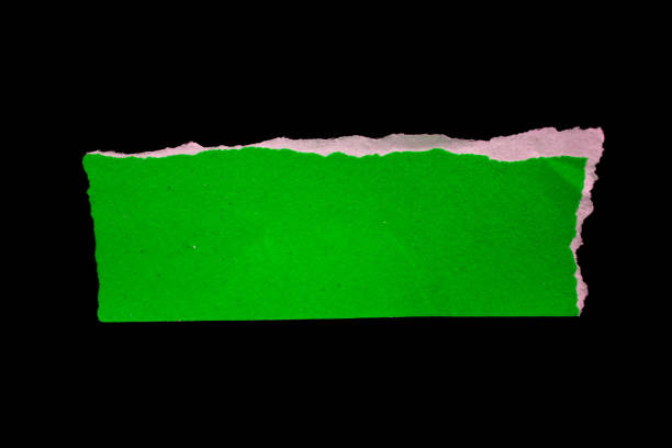 istock Ripped green paper piece isolated on a black background 1884816162