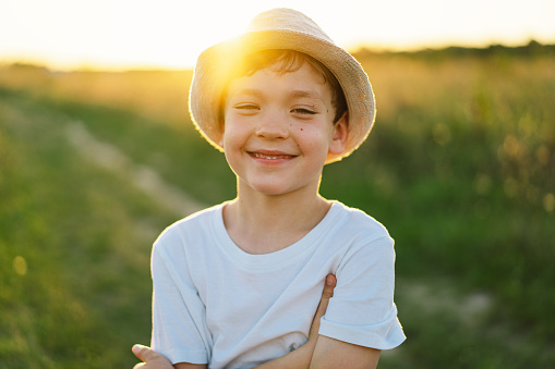 Close up photo portrait of a little blonde girl on a summer day