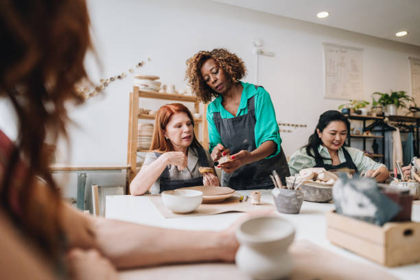 istock Pottery teacher teaching students at a ceramics workshop 1884826083