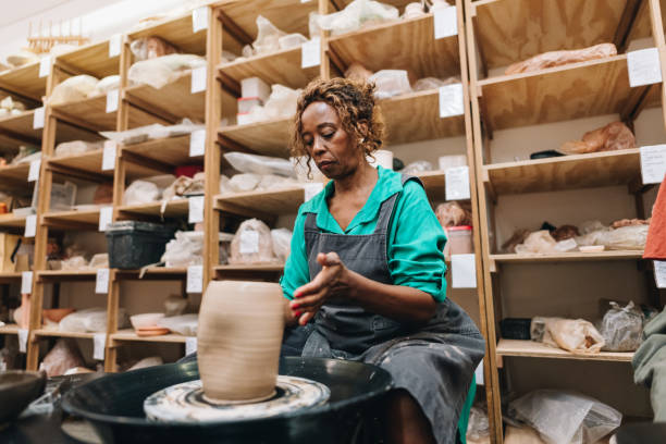 istock Senior woman making a vase on a ceramics workshop 1884835497