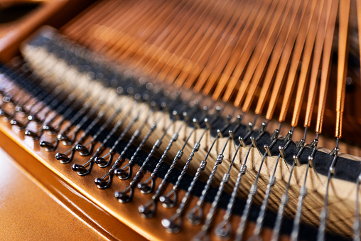 Close-up strings inside the piano. Stock photo.