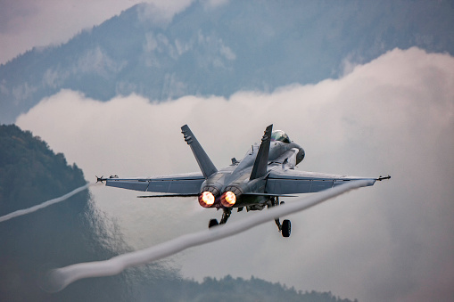 Jet fighter taking off displays its power with the afterburner