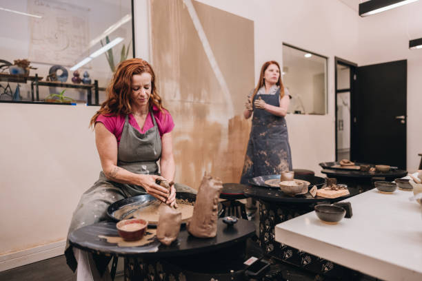 istock Mature woman on pottery class at a ceramics workshop 1884847090