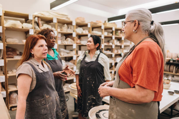 istock Potters friends talking on a ceramics workshop 1884847098