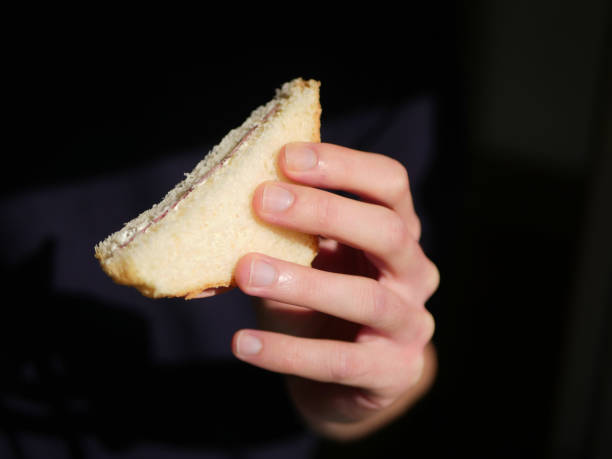 istock Man holding sandwich. Black background. 1884867516