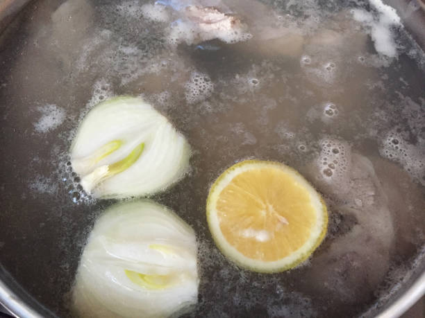 istock Bone meat with vegetables boiling in a saucepan. Bone broth 1884881230