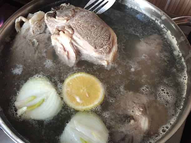 istock Meat bone with vegetables boiling in a saucepan 1884881755