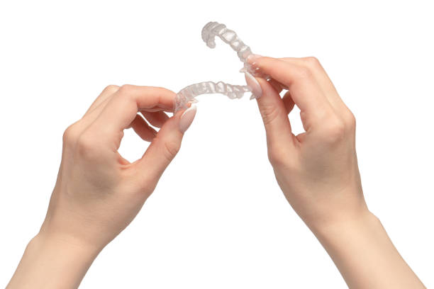 istock Transparent mouth guard in a woman's hand isolated on white background. 1884899630