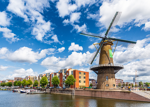 Rotterdam, Netherlands - July 30, 2023: The Distilleerketel windmill in the historic district of Delfshaven is still in activity.