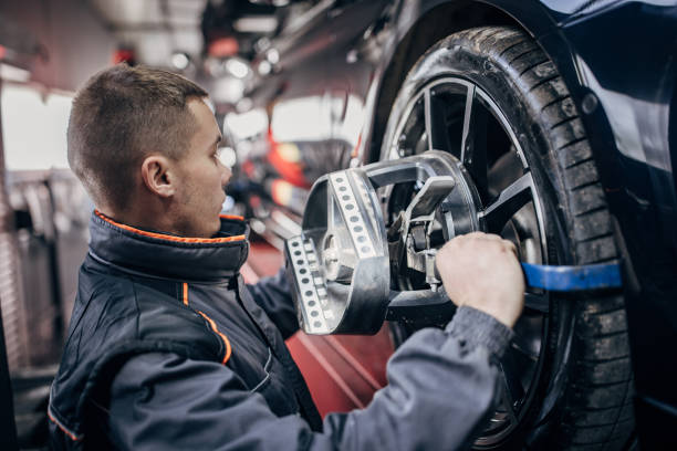 istock Mechanic sets the wheel alignment equipment on a car wheel 1884918038