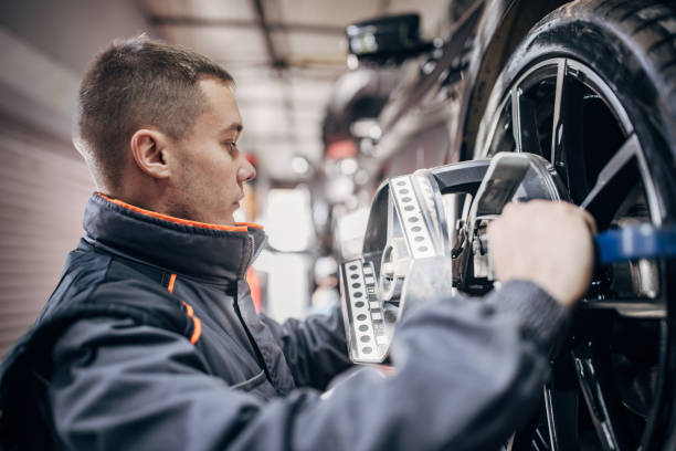 istock Mechanic sets the wheel alignment equipment on a car wheel 1884919134
