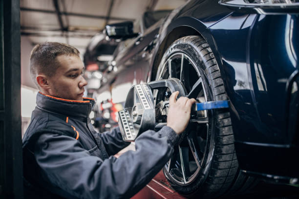 istock Mechanic sets the wheel alignment equipment on a car wheel 1884919673