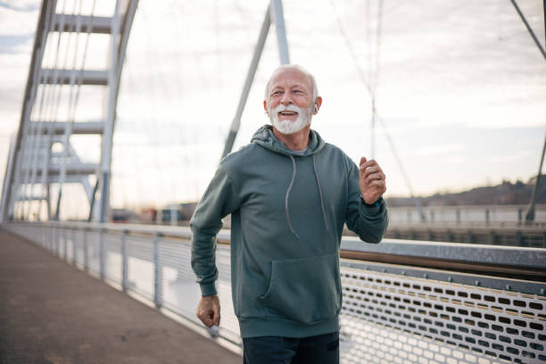 istock Senior man jogging on bridge 1884924586