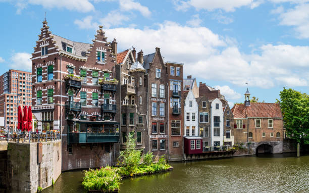 Delfshaven historic district in Rotterdam, Netherlands. Rotterdam, Netherlands - July 30, 2023: The Aelbrechtskolk is a former lock in the historic district of Delfshaven overlooked by the facades of medieval townhouses. brick cafe stock pictures, royalty-free photos & images