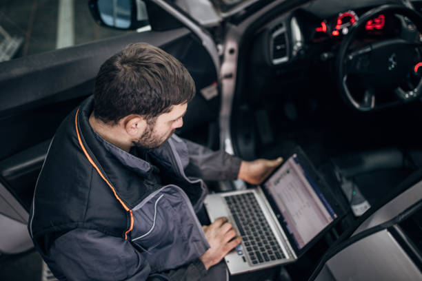 istock Mechanic doing car diagnostic in auto repair shop 1884939596