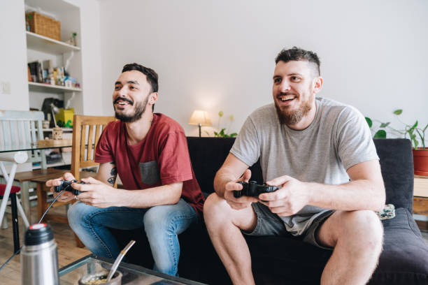 istock Friends playing video games at apartment 1884942779