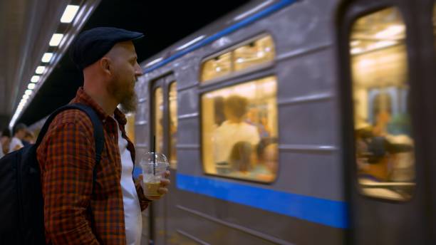 istock Metro train arrives platform, man coffee stands, transportation technology. integration technology daily commuting, station, advancements transportation technology efficient urban travel. 1884953960