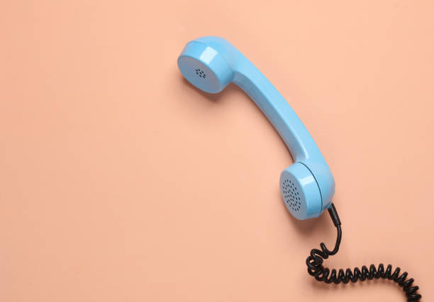 istock Retro blue telephone receiver on a pink background 1884960311