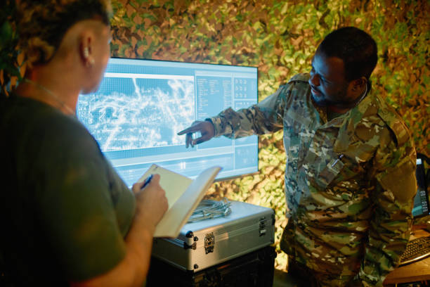 istock Young African American officer pointing at computer screen during report 1884974301