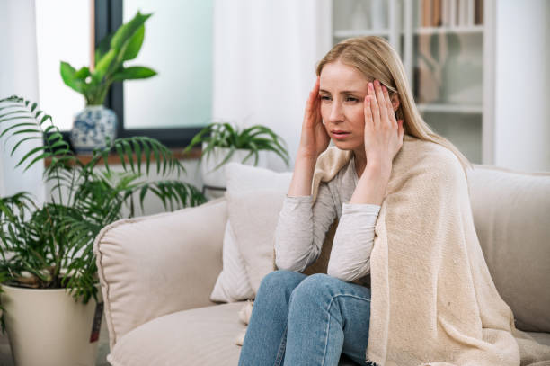 istock sick woman hold temples and feeling headache 1884989456