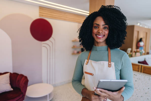 istock Portrait of a owner using digital tablet at coffee shop 1884993179