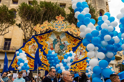 COSPICUA MALTA - December 08, 2023: Flags and Balloons at the Maltese village feast of Immaculate Conception at Cospicua