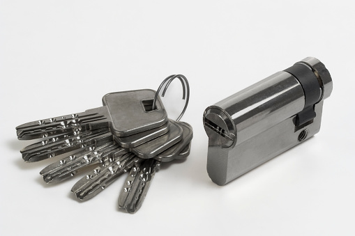 A chrome padlock with a key on a white background illustrates the key to success.
