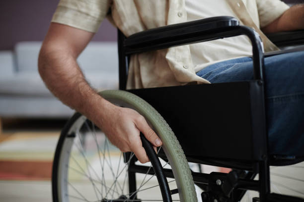 istock Person with Disability Turning Wheelchair Wheel 1885055521