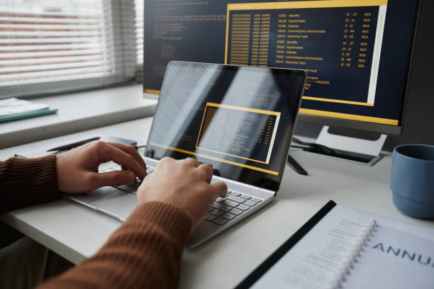 istock Close Up of Male Hands Typing at Laptop Keyboard and Writing Code 1885056046