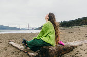 Happy Woman Contemplating Baker Beach in San Francisco, California Listening to Music