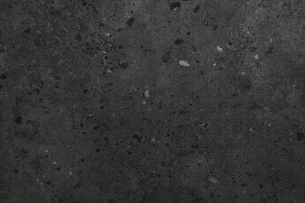 istock Texture of black concrete background. Light wallpaper with rough cement, tile texture. Decorative nature wall concept, surface mockup. Abstract grunge backdrop for art design. Top view, copy space 1885066953