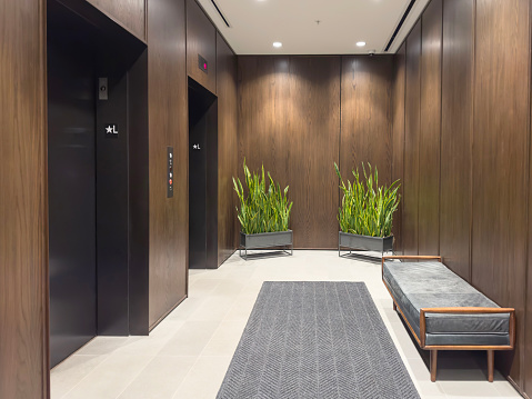 Chic elevator entrance hall with an empty bench