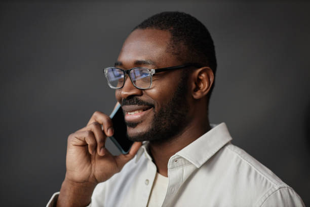 istock Black Man Wearing Glasses Speaking on Phone 1885094877