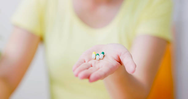 istock woman pour pills on hand 1885111816