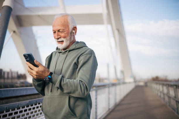 istock Modern senior man standing on bridge and talking with family 1885127377