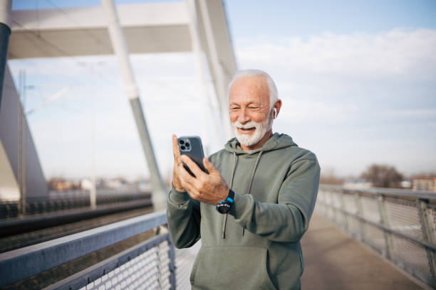 istock Modern senior man standing on bridge and talking with family 1885128438