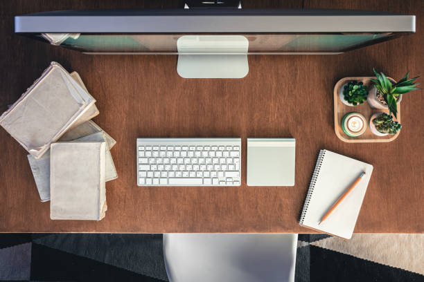 istock Student desk with computer, books and notepads on a wooden table. 1885131156