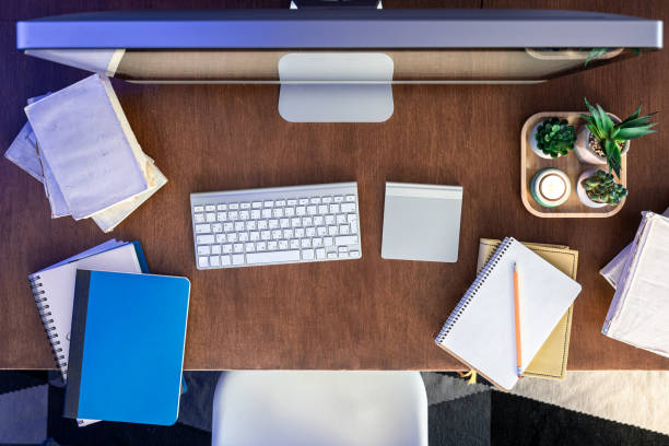 istock Student desk with computer, books and notepads on a wooden table. 1885131596