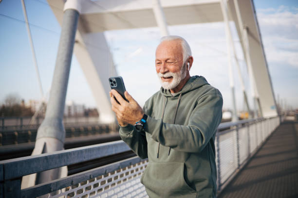 istock Modern senior man standing on bridge and talking with family 1885131612