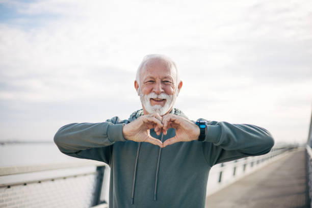 istock A senior man making a heart symbol with his hands 1885138340