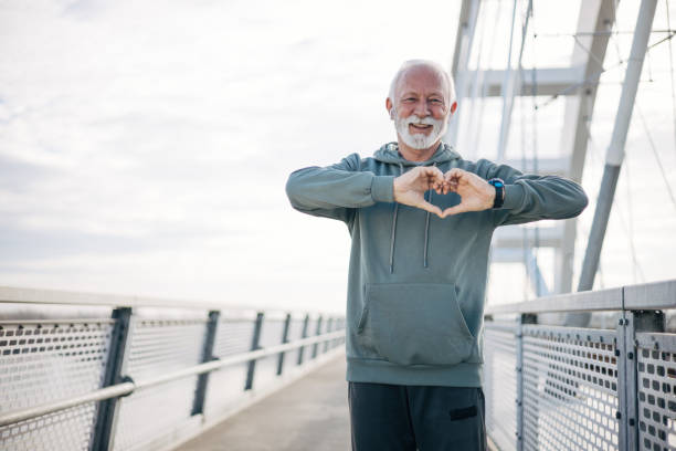 istock A senior man making a heart symbol with his hands 1885140382