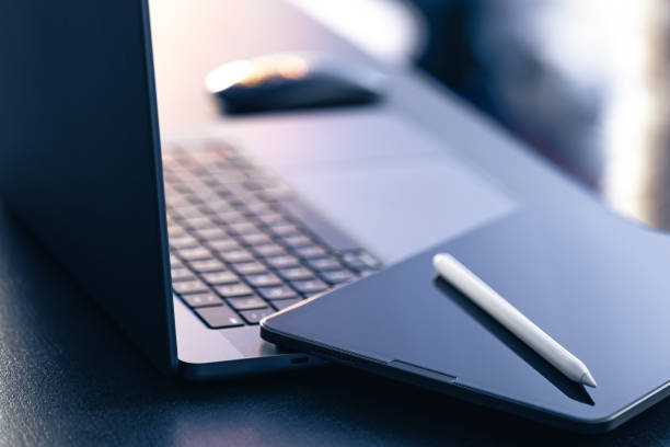 istock Digital tablet, stylus pen and laptop on the desktop, close up. 1885162076