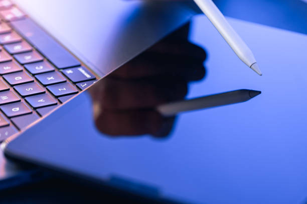 istock Man using digital tablet, holding stylus pen, working in office. 1885162080