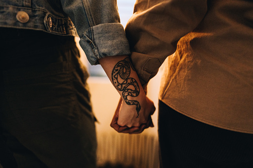 Close-up of a lesbian couple holding hands