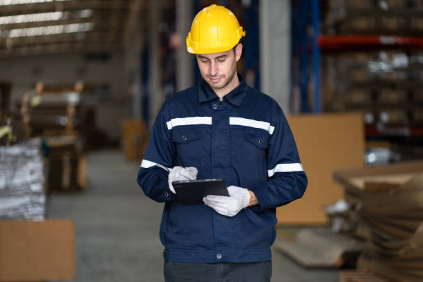istock Portrait Caucasian businessman workers using tablet computer checking Kraft paper stock in warehouse 1885170447