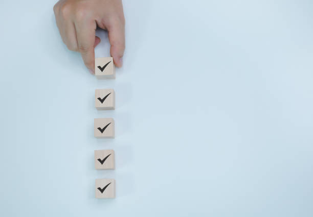 istock Businessman places correct marking wooden blocks next to each other for quality document checklist and business approval project concept. 1885206798