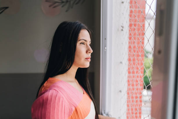 istock Young woman contemplating at home 1885218713