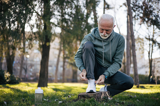 Senior man shoestring outdoors