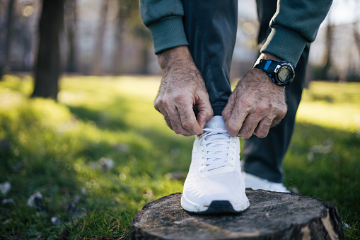 Senior man shoestring outdoors
