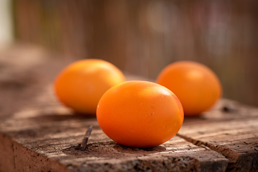 Orange Easter eggs on an old wooden table